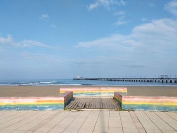 Scenic view of swimming pool by sea against sky