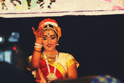 Portrait of smiling mature woman dancing during event