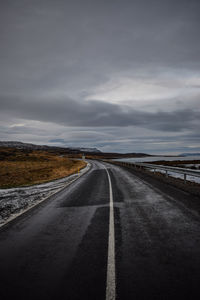 Country road against sky