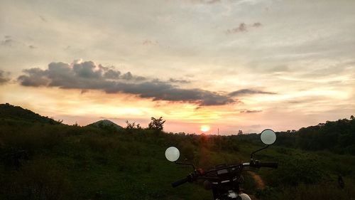 Scenic view of field against sky during sunset