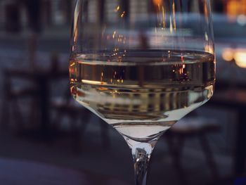 Close-up of white wine in glass on table