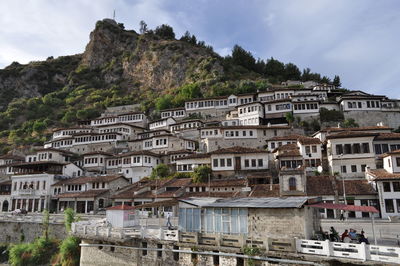 Low angle view of residential district by mountain