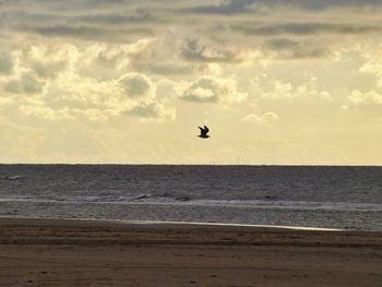 Scenic view of sea against sky at sunset