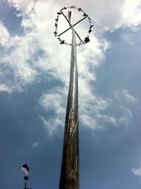 Low angle view of child against cloudy sky