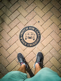 Low section of man standing on footpath