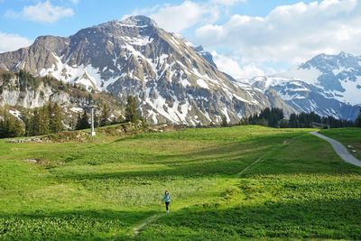 Scenic view of field and mountains against sky