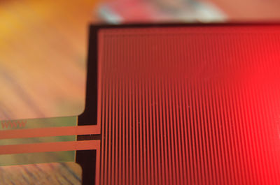 Close-up of red telephone on table