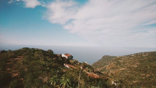 Scenic view of sea and mountains against sky