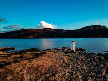 Scenic view of sea and mountains against sky