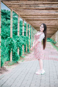 Woman standing on footpath