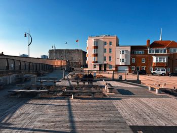 Buildings in city against blue sky