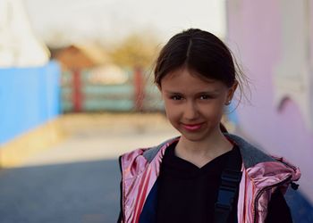 Portrait of smiling girl standing outdoors