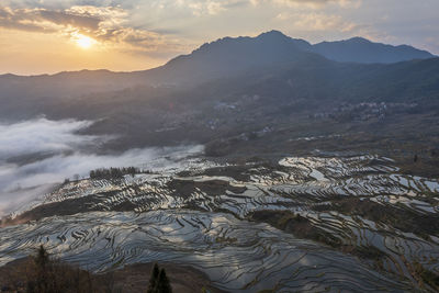 Scenic view of mountains against sky during sunset
