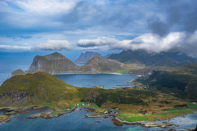 Scenic view of sea and mountains against sky