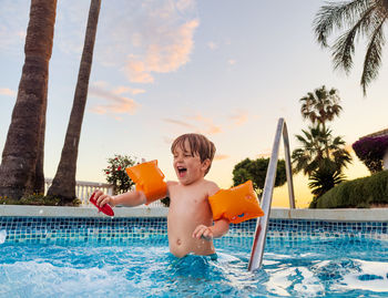 Portrait of young woman swimming in pool