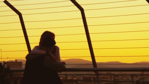 Silhouette of man standing at sunset