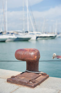 Close-up of rusty cleat at port