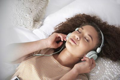 High angle portrait of woman relaxing on bed