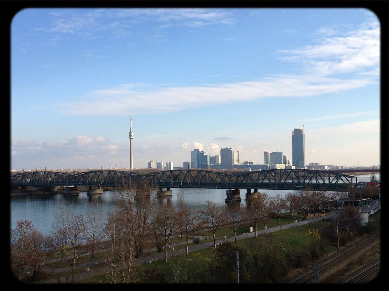 architecture, built structure, city, building exterior, water, cityscape, river, sky, transfer print, skyscraper, tower, auto post production filter, bridge - man made structure, urban skyline, capital cities, connection, tall - high, cloud - sky, modern, travel destinations