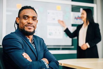 Portrait of young man standing in office