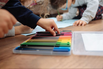 Children drawing on paper at home