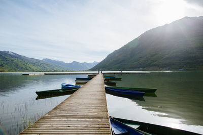 Jetty in lake against sky