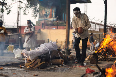 People with fire on street in city