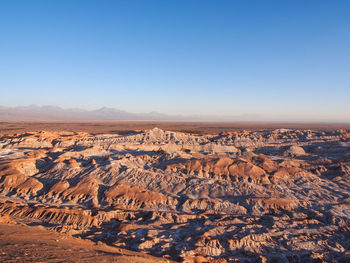 Aerial view of desert against clear sky