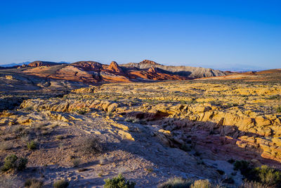 Scenic view of desert against clear blue sky