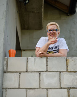 Portrait of a mature woman with eyeglasses smoking a cigarette