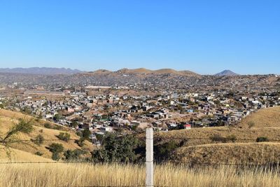 Scenic view of agricultural field against clear blue sky