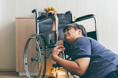 Side view of young man sitting on bicycle