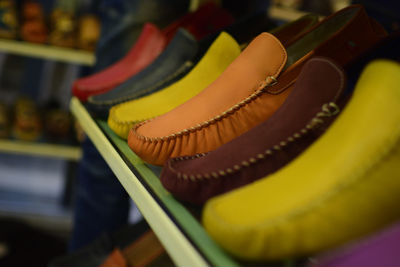 Close-up of multi colored shoes on display at store