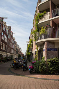 Cars in city against sky