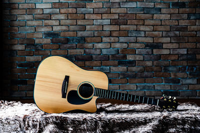 Close-up of guitar against wall