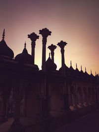 Low angle view of historic building against sky during sunset