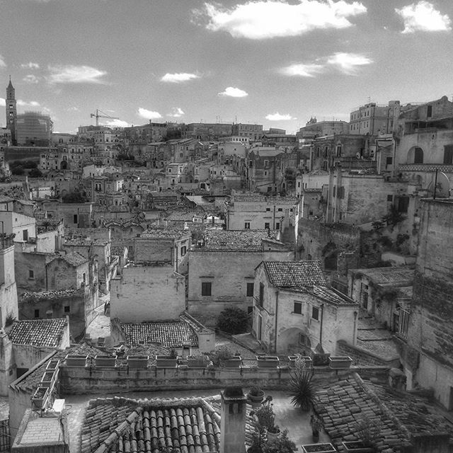 architecture, building exterior, built structure, high angle view, cityscape, sky, city, residential district, residential building, crowded, residential structure, history, town, roof, townscape, travel destinations, cloud - sky, day, old, house