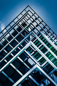 Low angle view of glass building against sky