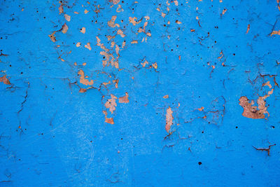 Old peeling paint on the wall closeup