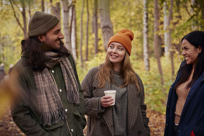 Friends talking in autumn forest