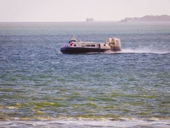 Boat sailing in sea against sky