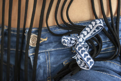 Close-up of ribbon toed to jeans