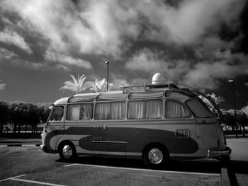 Van on parking lot against sky