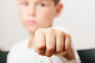 Close-up of boy gesturing fist