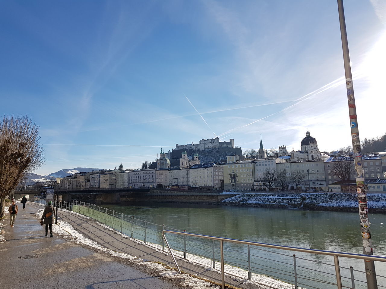 BRIDGE OVER RIVER BY CITY AGAINST SKY