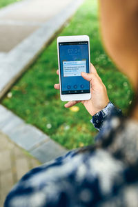 Midsection of man using mobile phone