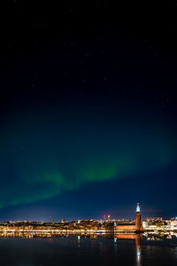 Stockholm city hall with aurora borealis in the night sky above