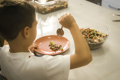 High angle view of man having food in plate