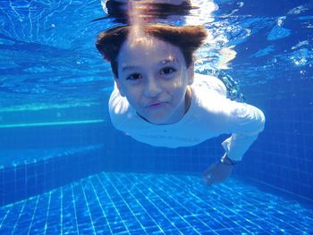 Portrait of boy swimming in pool