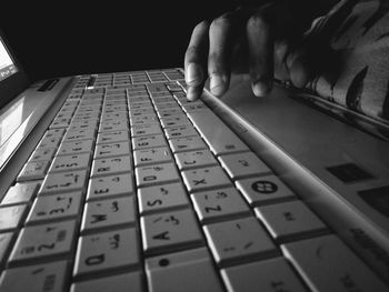 Close-up of man using laptop